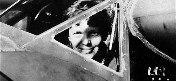 Undated picture taken in the 30' s of American female aviator Amelia Earhart looking trough the cockpit window of her plane. Amelia Earhart was the first woman to fly the Atlantic as a passenger, in 1928, and followed this by a solo flight in 1932. In 1935 she flew solo from Hawaï to Califofrnia. In 1937, with Fred Noonan, they set out to fly round the world, but their plane was lost over the Pacific, 02 July. (Photo credit should read STAFF/AFP/Getty Images)