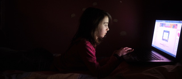 A girl plays video games on her computer on February 27, 2013 in Chisseaux near Tours, central France. AFP PHOTO/ ALAIN JOCARD (Photo credit should read ALAIN JOCARD/AFP/Getty Images)