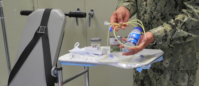 A US naval medic holds liquid food supplement force fed to hunger strikers at the US Naval Base in Guantanamo Bay, Cuba on August 7, 2013. The end of Ramadan is traditionally regarded as an unofficial truce at Guantanamo, where some inmates have been held for around a decade without trial. However officials expect the end of Ramadan and the festival of Eid al-Fitr will be the cue for trouble at Guantanamo, which has witnessed an unprecedented six-month hunger strike this year. Some inmates at Guantanamo have taken advantage of a tailored menu to observe the Eid holiday.This weekend inmates were offered halal chicken, halal beef, lamb, dates, honey, says kitchen manager Sam Scott. Some 38 other hunger-striking inmates, however, will continue to be force-fed by tubes, a practice which has been widely condemned by rights groups. The number of prisoners on hunger-strike has fallen, possibly as a result of Ramadan, when authorities traditionally offer to wipe clean the slates of inmates facing disciplinary proceedings. AFP PHOTO/CHANTAL VALERY (Photo credit should read CHANTAL VALERY/AFP/Getty Images)
