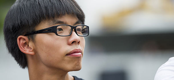 This picture taken on September 22, 2014 shows pro-democracy student activist Joshua Wong looking on during a strike at the Chinese University of Hong Kong. Thousands of Hong Kong students on September 22 were to begin a week-long boycott of classes, kicking off what democracy activists say will be a wider campaign of civil disobedience against Beijing's refusal to grant the city full universal suffrage. AFP PHOTO / XAUME OLLEROS (Photo credit should read XAUME OLLEROS/AFP/Getty Images)