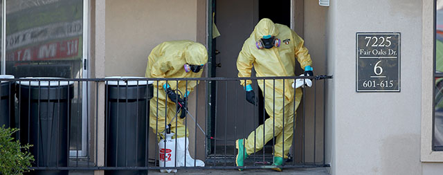 DALLAS, TX - OCTOBER 06: Members of the Cleaning Guys Haz Mat clean up company are seen as they work on sanitizing the apartment where Ebola patient Thomas Eric Duncan was staying before being admitted to a hospital on October 6, 2014 in Dallas, Texas. The first confirmed Ebola virus patient in the United States was staying with family members at The Ivy Apartment complex before being treated at Texas Health Presbyterian Hospital Dallas. State and local officials are working with federal officials to monitor other individuals that had contact with the confirmed patient. (Photo by Joe Raedle/Getty Images)