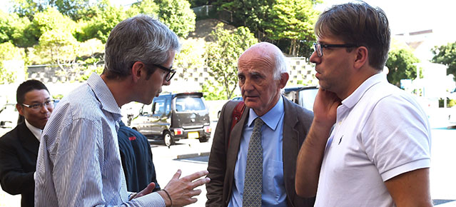 FIA doctor Gerard Saillant (C) and Morgan Caron, French Automobile Federation's representative for young drivers (R) listens to Marussia driver Jules Bianchi of France's assistant manager, Alessandro Alunni Bravi (L) upon their arrival at the Mie General Medical Centre in Yokkaichi on October 7, 2014. The French driver underwent emergency surgery on October 5 after slamming into a recovery vehicle on the Suzuka track near the end of a rain-sodden Japanese Grand Prix. AFP PHOTO / TOSHIFUMI KITAMURA (Photo credit should read TOSHIFUMI KITAMURA/AFP/Getty Images)