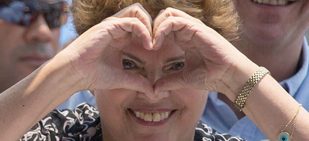 Brazilian president and presidential candidate of the Workers Party (PT) Dilma Rousseff makes a heart-shaped sign during her campaign in Rio de Janeiro, Brazil, on October 20, 2014. Rousseff will face Aecio Neves, presidential candidate of the Brazilian Social Democracy Party (PSDB), in a run-off election next October 26. AFP PHOTO / YASUYOSHI CHIBA (Photo credit should read YASUYOSHI CHIBA/AFP/Getty Images)