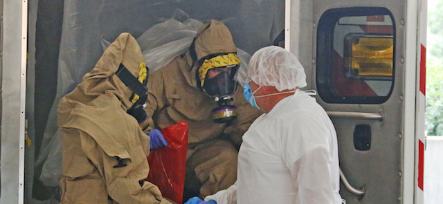 A patient transported from Frisco, TX with concerns of possible exposure to Ebola arrives at the Emergency Room entrance of Texas Health Presbyterian Hospital of Dallas in Dallas, TX on Wednesday, Oct. 8, 2014. (AP Photo/The Dallas Morning News, Louis DeLuca)