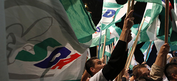 Bosnian supporters wave with flag during rally of the SDA (Party of Democratic Action) ruling Bosnian Muslim Party, in Sarajevo, on Friday, Oct. 10, 2014. Bosnia holds general elections on Sunday. (AP Photo/Amel Emric)