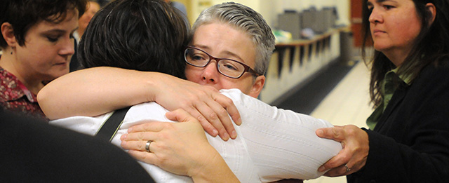 Lori Watson, of Boise, hugs Sheila Robertson at the Ada County Courthouse after same sex couples were denied a wedding license on Wednesday, Oct. 8, 2014. U.S. Supreme Court Justice Anthony Kennedy has temporarily blocked an appeals court ruling that declared gay marriage legal in the states of Idaho and Nevada. The order came minutes after Idaho on Wednesday filed an emergency request for an immediate stay. May-Chang, married her partner two years ago and supporting friends who were seeking a marriage license. (AP Photo/The Idaho Press-Tribune, Adam Eschbach ) MANDATORY CREDIT