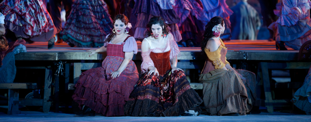 Opera singers and actors perform during a full dress rehearsal of George Bizet's opera "Carmen" on a special stage set up against the backdrop of the ancient hilltop fortress of Masada, southern Israel, on June 6, 2012. Israeli maestro Daniel Oron will conduct the Israeli opera orchestra and chorus with lead roles being sung by international opera singers. AFP PHOTO/MENAHEM KAHANA (Photo credit should read MENAHEM KAHANA/AFP/GettyImages)