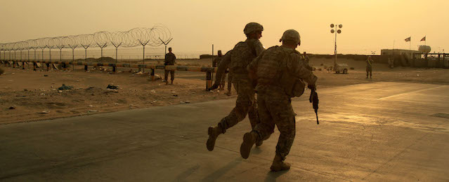 FILE - In this Wednesday, Aug. 18, 2010 file photo, U.S. Army soldiers from 2nd Battalion, 23rd Infantry Regiment, 4th Brigade, 2nd Infantry Division race toward the border from Iraq into Kuwait. President Barack Obama on Friday Oct. 21, 2011 declared an end to the Iraq war, one of the longest and most divisive conflicts in U.S. history, announcing that all American troops would be withdrawn from the country by year's end.(AP Photo/Maya Alleruzzo, File)
