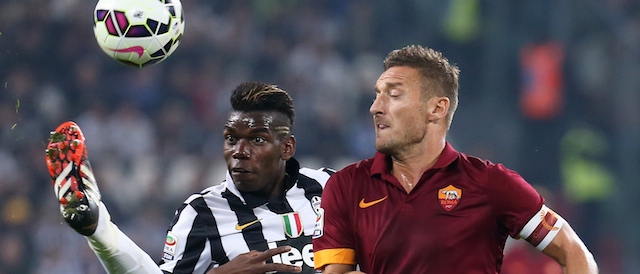 Juventus' French midfielder Labile Paul Pogba fights for the ball with AS Roma forward and captain Francesco Totti during the Italian Serie A football match Juventus Vs AS Roma on October 5, 2014 at Juventus Stadium in Turin. AFP PHOTO / MARCO BERTORELLO (Photo credit should read MARCO BERTORELLO/AFP/Getty Images)
