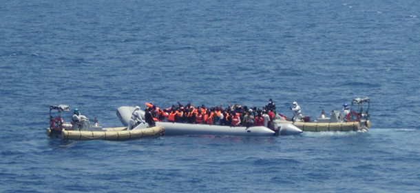 In this photo released by the Italian Navy on Sunday, June 15, 2014, and taken on Saturday, June 14, 2014, a fishing boat filled with migrants receives aid from Italian Navy motor boats off the coast of Sicily, Italy. The Italian coast guard and navy have rescued more than 300 migrants whose boats ran into trouble in the Mediterranean Sea and recovered the bodies of 10 migrants whose dinghy had overturned. Naval official Salvatore Scimone said 39 survivors on Saturday had grabbed onto the dinghy until rescuers plucked them to safety aboard another boat. He said he feared that an undetermined number of others were missing in the sea north of Libya. In a separate rescue, three Italian ships took aboard 281 migrants who said they were Syrian and whose fishing boat ran into problems. (AP Photo/Italian Navy, ho)