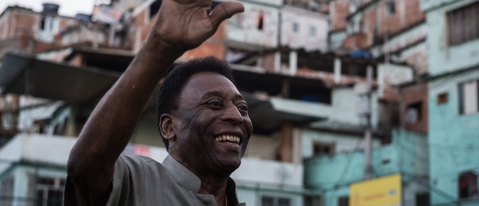 Legendary Brazilian former football player Pele waves during the inauguration ceremony of the new technology football pitch installed at Mineira favela in Rio de Janeiro, Brazil, on September 10, 2014. 200 self energy supplied Pavegen panels, invented by British Laurence Kemball-Cook, were installed underground to capture kinetic energy created by the movement of the football players. The energy is stored and combined with solar panels' energy to illuminate the pitch during the night. The new technology pitch was created by oil giant Royal Dutch Shell. AFP PHOTO / YASUYOSHI CHIBA (Photo credit should read YASUYOSHI CHIBA/AFP/Getty Images)