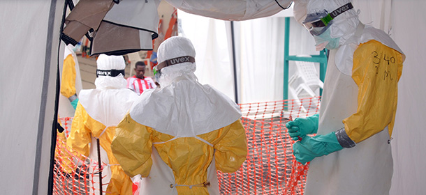 Health workers wearing Personal Protective Equipments (PPE) enter the Ebola treatment center run by the non-governmental international organization Medecins Sans Frontieres (Doctors without Borders -- MSF) in Monrovia, Liberia, on October 27, 2014. The Red Cross said on October 28, 2014 the weekly total of Ebola victims collected by its body disposal teams around the Liberian capital is falling dramatically, indicating a sharp drop in the spread of the epidemic. Nearly 4,900 people have died from Ebola in west Africa, with almost 10,000 infected, according to the latest World Health Organization figures. AFP PHOTO / ZOOM DOSSO (Photo credit should read ZOOM DOSSO/AFP/Getty Images)