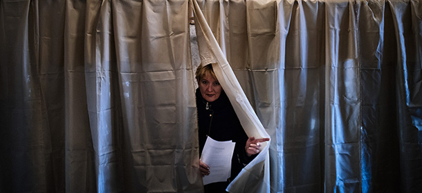 A woman leaves a voting booth during the vote in a polling station in Donetsk on November 2, 2014. Pro-Russian separatists in eastern Ukraine began voting in controversial leadership elections on Sunday that Kiev and the West have refused to recognise and which threatened to deepen an international crisis over the conflict. The elections in the self-declared Donetsk People's Republic and Lugansk People's Republic, which are based around the two main rebel-held cities, were designed to bring a degree of legitimacy to the makeshift military regimes that already control them. AFP PHOTO / DIMITAR DILKOFF (Photo credit should read DIMITAR DILKOFF/AFP/Getty Images)