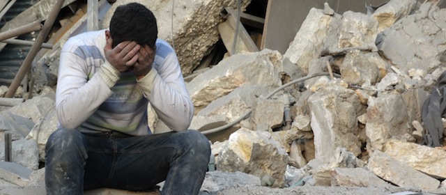 A man reacts to the destruction in the northern Syrian city of Aleppo on February 16, 2014. The death toll in nearly three years of conflict in Syria has risen to more than 140,000 people including nearly 50,000 civilians, the Syrian Observatory for Human Rights said. AFP PHOTO/AMC/KHALED KHATIB (Photo credit should read KHALED KHATIB/AFP/Getty Images)