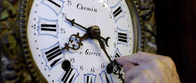 PLANTATION, FL- NOVEMBER 02: Howie Brown adjusts the time on a clock back one hour for the end of day light savings time at Brown's Old Time Clock Shop November 2, 2007 in Plantation, Florida. The end of daylight-saving time goes into effect this weekend and everyone is reminded to set their clock back one hour beginning at 2 am Sunday. (Photo by Joe Raedle/Getty Images) *** Local Caption *** Howie Brown