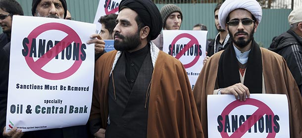 Two clergymen joining a group of Iranian students attend a gathering in front of the headquarters of Iran's Atomic Energy Organization, to show their support for Iran's nuclear program in Tehran, Iran, Sunday, Nov. 23, 2014. With a deadline approaching for a nuclear deal, an Iranian official said Sunday that the discussion may soon have to shift from trying to reach an agreement to extending negotiations past the target date. (AP Photo/Ebrahim Noroozi)