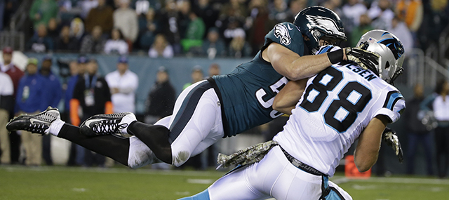 Carolina Panthers' Greg Olsen (88) is tackled by Philadelphia Eagles' Casey Matthews (50) after catching a pass during the first half of an NFL football game, Monday, Nov. 10, 2014, in Philadelphia. (AP Photo/Matt Rourke)