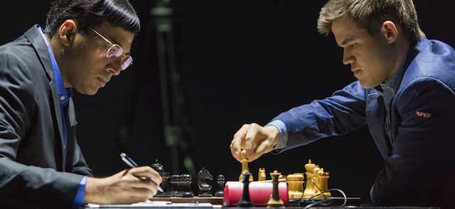 Norway's Magnus Carlsen, currently the top ranked chess player in the world, right, makes a move as he plays against India's former World Champion Vishwanathan Anand at the FIDE World Chess Championship Match in Sochi, Russia, Sunday, Nov. 9, 2014. (AP Photo/Artur Lebedev)