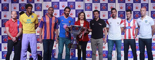 Indian Super League (ISL) founding chairperson Nita Ambani, center, poses with `players from left, Swedish footballer Fredrik Ljungberg who will play for the Mumbai team, English footballer David James, who will play for the Kerala Blasters team, French footballer David Trezeguet, who will play for the Pune team, French footballer Robert Pires who will play for the Goa team, Italian footballer Alessandro Del Piero, who will play for the Delhi Dynamos team, Spanish footballer Joan Capdevila, who will play for the North East United team, Spanish footballer Luis García, who will play for the Atlético de Kolkata team and French footballer Mikaël Silvestre who will play for the Chennaiyin team during the unveiling of the ISL trophy in Mumbai, India, Sunday, Oct. 5, 2014. The eight-team ISL kicks off on Oct.12. (Staffing/Rafiq Maqbool)