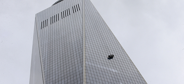 A partially collapsed scaffolding hangs from the 1 World Trade Center in New York, Wednesday, Nov. 12, 2014. New York City firefighters have been called to the nation's tallest skyscraper, where two workers are stuck on scaffolding 69 stories above street level. (AP Photo/Kathy Willens)