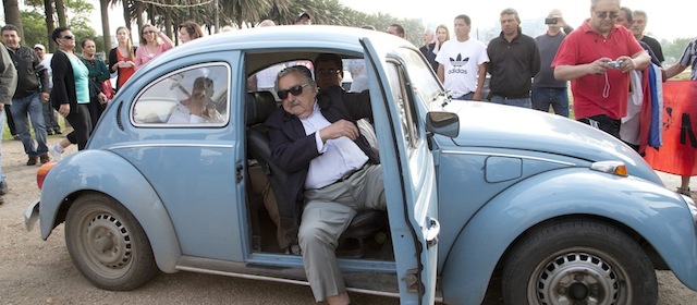 Uruguay's President Jose Mujica arrives at a polling station in his Volkswagen beetle, to cast his vote in the general elections, in Montevideo, Uruguay, Sunday, Oct. 26, 2014. Mujica led Uruguay through economic prosperity and gained worldwide acclaim for social reforms such as the legalization of marijuana and gay marriage. Left-leaning former President Tabare Vazquez of the Broad Front coalition won the most votes in Uruguay’s presidential election Sunday, but he fell short of the outright majority needed to avoid a Nov. 30 runoff, exit polls said.(AP Photo/Natacha Pisarenko)