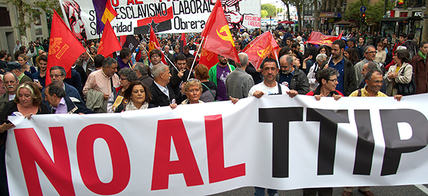 Protesters take part in demonstration against Transatlantic Trade and Investment Partnership (TTIP) in Madrid on October 11, 2014. European and US negotiators have been in talks for more than a year to create the world's biggest free-trade and investment agreement, the proposed TTIP. But the ambitious pact has raised an array of concerns about issues including whether it will override local laws, and sharp accusations that negotiations are taking place behind closed doors to protect the advance of corporate interests. AFP PHOTO / CURTO DE LA TORRE