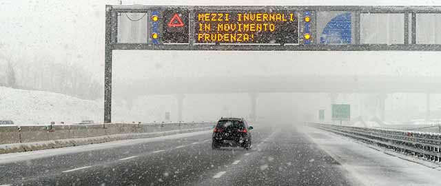 Cars drive slowly during heavy snow falls on the highway between Turin and Milan on January 30, 2011. Bad weather with heavy snowfalls hit the north of Italy. Placard reads: "Winter months, drive carefully!" AFP PHOTO / OLIVIER MORIN (Photo credit should read OLIVIER MORIN/AFP/Getty Images)