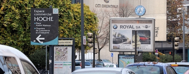 Vehicles are seen next to advertising billboards, on November 25, 2014, in Grenoble a few days after the mayor of Grenoble announced the ban of commercial street advertising to make way for trees and community noticeboards. Between January and April, 326 advertising signs, including 64 billboards, will be taken down and the city's outdoor advertising contract will be cancelled. AFP PHOTO/ JEAN-PIERRE CLATOT (Photo credit should read JEAN-PIERRE CLATOT/AFP/Getty Images)