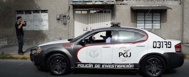 A police car remains idle in front of one of the houses investigated by the police during the search of the mayor of Iguala Jose Luis Abarca, on November 4, 2014, in Mexico City. Mexican police detained Tuesday the fugitive ex-mayor and his wife accused of ordering a police attack that left six people dead and 43 college students missing since last month. AFP PHOTO/RONALDO SCHEMIDT (Photo credit should read RONALDO SCHEMIDT/AFP/Getty Images)