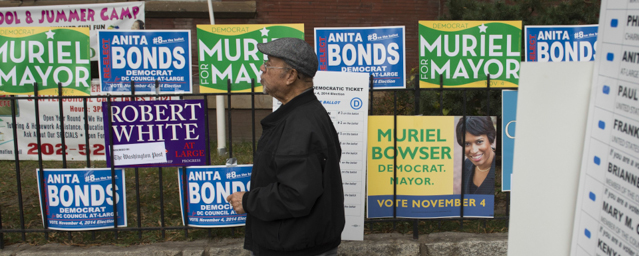 Campaign signs are seen outside a polling place as voters cast their ballots for the midterm elections in Washington, DC, November 4, 2014. AFP PHOTO / Saul LOEB (Photo credit should read SAUL LOEB/AFP/Getty Images)