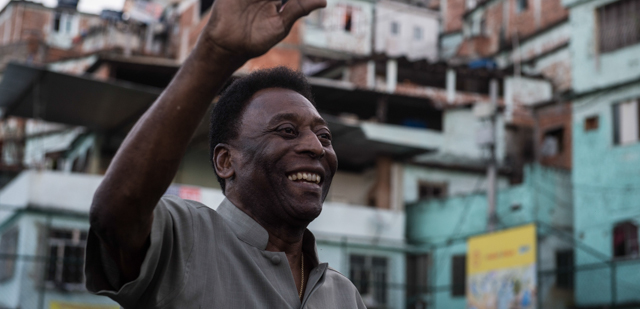 Legendary Brazilian former football player Pele waves during the inauguration ceremony of the new technology football pitch installed at Mineira favela in Rio de Janeiro, Brazil, on September 10, 2014. 200 self energy supplied Pavegen panels, invented by British Laurence Kemball-Cook, were installed underground to capture kinetic energy created by the movement of the football players. The energy is stored and combined with solar panels' energy to illuminate the pitch during the night. The new technology pitch was created by oil giant Royal Dutch Shell. AFP PHOTO / YASUYOSHI CHIBA (Photo credit should read YASUYOSHI CHIBA/AFP/Getty Images)
