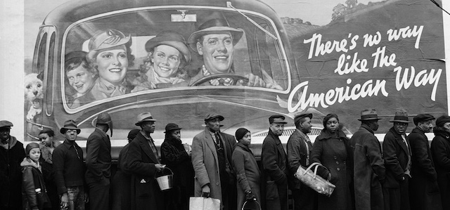 Famous image of African American flood victims lined up to get food &amp; clothing fr. Red Cross relief station in front of billboard ironically extolling "world's highest standard of living/ there's no way like the American way."
