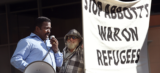 A man addresses the crowd at a rally protesting the Australian government's treatment of Sri Lankam asylum-seekers in Sydney on July 7, 2014. Canberra confirmed on July 7 that a boatload of Sri Lankan asylum-seekers who attempted to reach Australia have been handed back to Colombo, sparking sharp criticism after a week of secrecy. AFP PHOTO / Willliam WEST (Photo credit should read WILLIAM WEST/AFP/Getty Images)