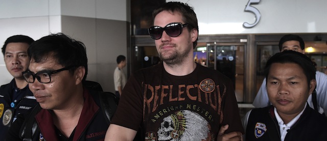 Swedish co-founder of the Pirate Bay website Fredrik Neij (C), 36, is taken by Thai immigration police officers at Don Mueang airport, to an immigration detention centre in Bangkok on November 5, 2013. The Swedish co-founder of the Pirate Bay website is due to be hauled to Bangkok following his arrest in northeast Thailand, with police from Stockholm waiting to press for his deportation to serve a jail term for copyright infringement. AFP PHOTO/ Nicolas ASFOURI (Photo credit should read NICOLAS ASFOURI/AFP/Getty Images)