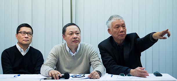 Pro-democracy activists Benny Tai (C) attends a press conference with Chan Kin-man (L) and Chu Yiu-ming (R) in Hong Kong on December 2, 2014. The three original founders of Hong Kong's pro-democracy Occupy movement tearfully announced they would "surrender" by turning themselves into police and urged protesters still on the streets to retreat. AFP PHOTO / Johannes EISELE (Photo credit should read JOHANNES EISELE/AFP/Getty Images)