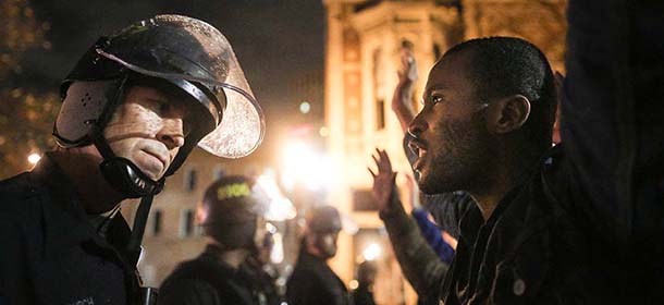 OAKLAND, CA - DECEMBER 3: Protesters face off following a Staten Island, New York grand jury's decision not to indict a police officer in the chokehold death of Eric Garner on December 3, 2014 in Oakland, California. The grand jury declined to indict New York City Police Officer Daniel Pantaleo in Garner's death. (Photo by Elijah Nouvelage/Getty Images)