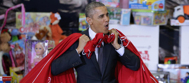 WASHINGTON, DC - DECEMBER 10: U.S. President Barack Obama, with bags slung over his shoulders, delivers toys and gifts donated by Executive Office of the President staff to the Marine Corps Reserve Toys for Tots Program at Joint Base Anacostia-Bolling December 10, 2014 in Washington, DC. For 67 years the Toys for Tots program has worked with local communities to collect and distribute toys and gifts for less fortunate children throughout the United States. (Photo by Chip Somodevilla/Getty Images)