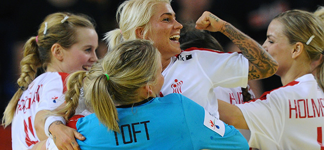 Denmark's players celebrate with staff member their victory over Hungary in Fonix Hall of Debrecen on December 15, 2014 after their Main Round I match of Women's European Championships. Denmark won 23-20. AFP PHOTO / ATTILA KISBENEDEK (Photo credit should read ATTILA KISBENEDEK/AFP/Getty Images)
