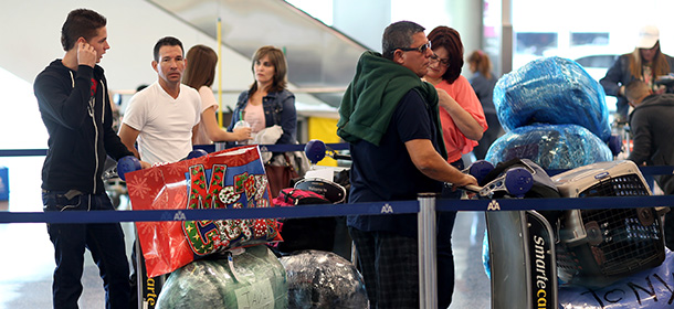 MIAMI, FL - DECEMBER 19: People wait in line to check luggage at the ABC Charters American Airlines flight to Havana, Cuba at Miami International Airport on December 19, 2014 in Miami, Florida. U.S. President Barack Obama announced a relaxation in the Cuban policy which may mean more travel between the United States and Cuba. (Photo by Joe Raedle/Getty Images)