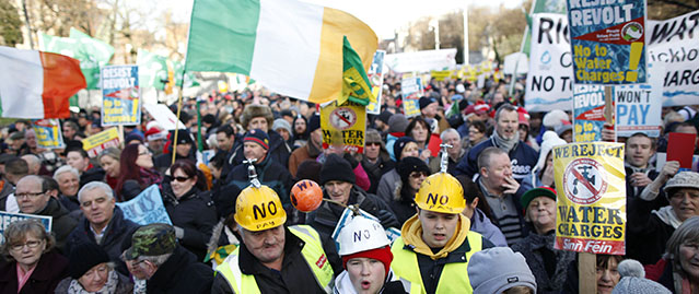 Thousands of water tax protesters congregate close to government buildings in Dublin city centre, Ireland, Wednesday, Dec. 10, 2014. Thousands of people attended the protest Wednesday in Dublin against the introduction of water tax charges in the Republic of Ireland. (AP Photo/Peter Morrison)