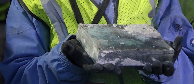 Pamela Hatchfield, a conservator at the Boston's Museum of Fine Arts, holds a time capsule she removed from the cornerstone of the Statehouse in Boston, Thursday, Dec. 11, 2014. Secretary of State William Galvin said the 200-year-old time capsule is believed to contain items such as old coins and newspapers, but the condition of the contents isn’t yet known. (AP Photo/Stephan Savoia)