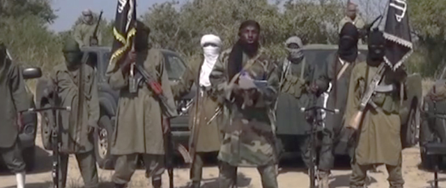 This Friday Oct. 31, 2014 image taken from video by Nigeria's Boko Haram terrorist network, the leader of Nigeria's Islamic extremist group Boko Haram, center, has denied agreeing to any cease-fire with the government and said Friday more than 200 kidnapped schoolgirls all have converted to Islam and been married off. (AP Photo)