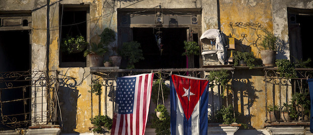 A U.S. and Cuban flag hang from the same balcony in Old Havana, Cuba, Friday, Dec. 19, 2014. After the surprise announcement on Wednesday of the restoration of diplomatic ties between Cuba and the U.S., many Cubans expressed hope that it will mean greater access to jobs and the comforts taken for granted elsewhere, and lift their struggling economy. However others feared a cultural onslaught, or that crime and drugs, both rare in Cuba, will become common along with visitors from the United States. (AP Photo/Ramon Espinosa)