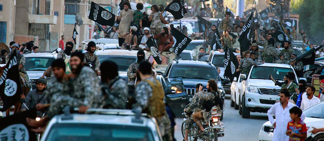 FILE - In this undated file image posted on Monday, June 30, 2014, by the Raqqa Media Center of the Islamic State group, a Syrian opposition group, which has been verified and is consistent with other AP reporting, fighters from the Islamic State group parade in Raqqa, north Syria. In the early dawn of Nov. 2, militant leaders with the Islamic State group and al-Qaida gathered at a farm house in northern Syria and sealed a deal to stop fighting each other and work together against their opponents, a prominent Syrian opposition official and a rebel commander said. Such an alliance could be a significant blow to struggling U.S-backed Syrian rebels. (AP Photo/Raqqa Media Center of the Islamic State group, File)