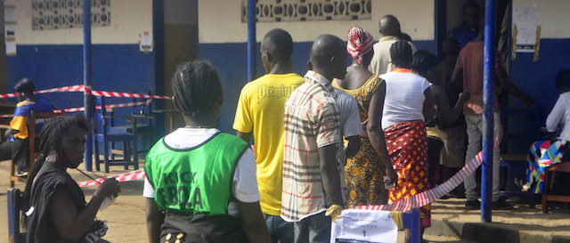 Liberians queue to cast their votes during the senate election in Monrovia, Liberia. Saturday, Dec. 20, 2014. Health workers manned polling stations across Liberia on Saturday as voters cast their ballots in a twice-delayed Senate vote that has been criticized for its potential to spread the deadly Ebola disease. (AP Photo/Abbas Dulleh)