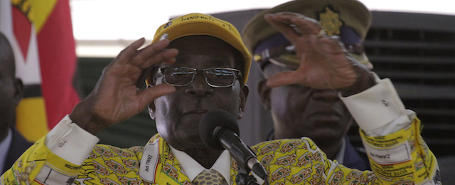 Zimbabwean President Robert Mugabe delivers his speech during the official opening of the Zanu pf 6th National Congress in Harare, Thursday, Dec. 4, 2014. Mugabe attacked his deputy President Joice Mujuru aledging she plotted to remove him from power.(AP Photo/Tsvangirayi Mukwazhi)