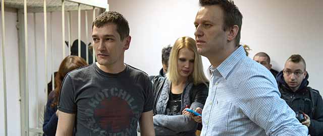Russian anti-Kremlin opposition leader Alexei Navalny (R) and his brother and co-defendant Oleg attend the verdict announcement of their fraud trial at a court in Moscow on December 30, 2014. A Russian court on December 30 handed a 3.5-year suspended sentence to top Kremlin critic Alexei Navalny in his controversial fraud trial, after abruptly moving forward the reading of the verdict. Judge Yelena Korobchenko found Navalny and his brother Oleg guilty of embezzlement. But while Navalny received a suspended sentence, his brother was handed a 3.5-year prison term and handcuffed in the courtroom in a move that Navalny angrily denounced as political 'pressure.' AFP PHOTO / DMITRY SEREBRYAKOV (Photo credit should read DMITRY SEREBRYAKOV/AFP/Getty Images)