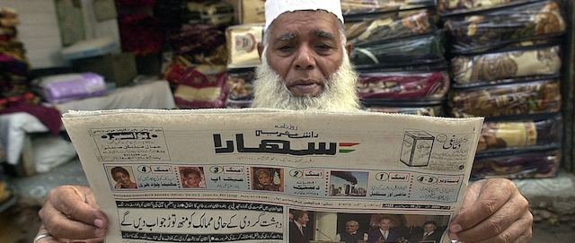 Haji Jameel Ahmed, an Indian Muslim, reads an Urdu newspaper outside his shop near Delhi's Jama Masjid mosque, 07 October 2001. India, home to the second largest Muslim population in the world, may find that backing a US-led campaign in Afghanistan could alienate its Muslim population. AFP PHOTO/PRAKASH SINGH (Photo credit should read PRAKASH SINGH/AFP/Getty Images)