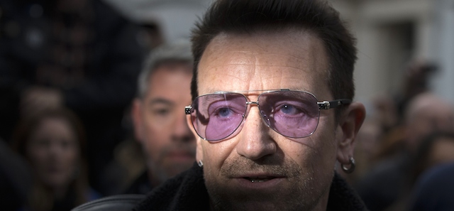 U2 frontman Bono arrives at a west London studio to record the new Band Aid 30 single on November 15, 2014. Bob Geldof, One Direction, Bono and some 30 other stars gathered in a studio in London on Saturday to record a 30th anniversary version of the Band Aid charity single to raise money to fight Ebola. Led Zeppelin's Robert Plant, Coldplay's Chris Martin and Sinead O'Connor were also among the rockers brought together by Geldof to sing the fourth version of "Do They Know It's Christmas?" Musicians began arriving in the early morning and were expected to record all day and into the night before the single is aired for the first time on Sunday and then officially released on Monday. AFP PHOTO / ANDREW COWIE