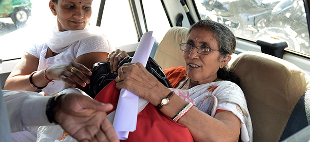 Indian Prime Minister Narendra Modi's wife, Jashodaben (R) holds a copy of the Right To Information (RTI) application filed by her as she leaves the Deputy Superintendent of Police (DSP) office in Mehsana, some 70 kms from Ahmedabad on November 24, 2014. An RTI application requesting an explanation of the sort of government security she receives, has been filed by retired school-teacher, Jashodaben. AFP PHOTO / Sam PANTHAKY (Photo credit should read SAM PANTHAKY/AFP/Getty Images)